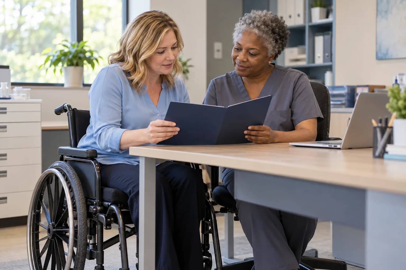 Clinic administrator and nurse discussing operations at an accessible workspace.