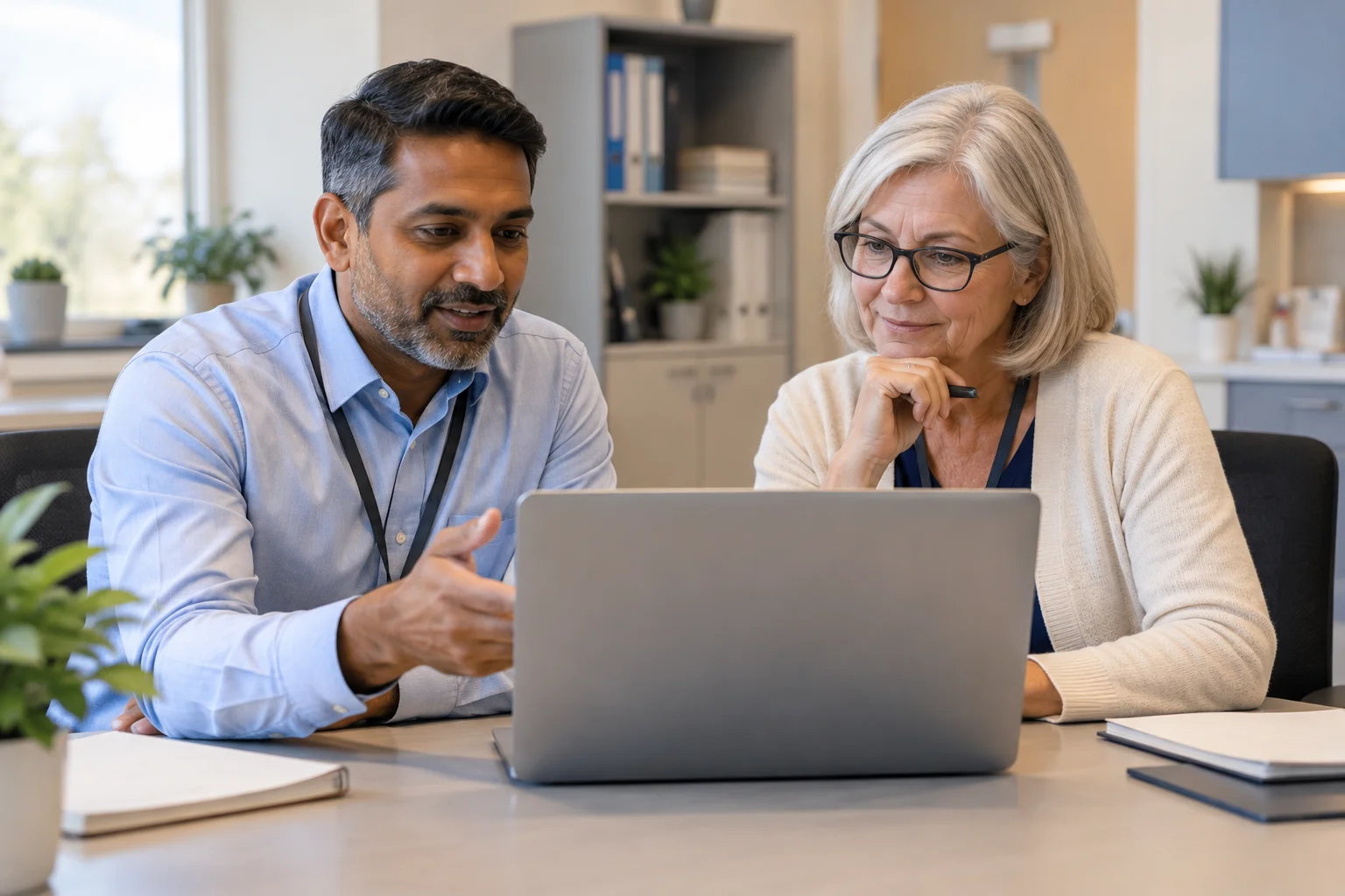 IT professional and clinic manager discussing digital security.