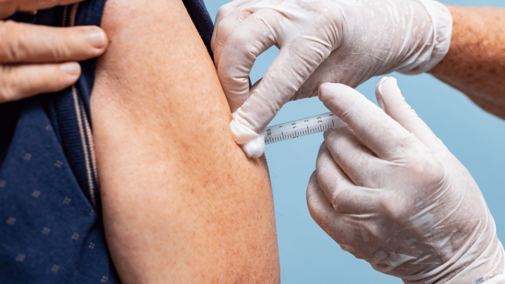 Person getting vaccinated in left arm