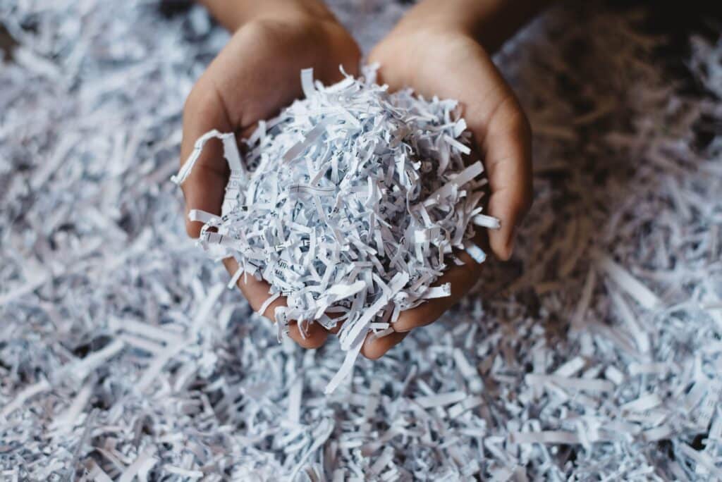 Hands holding shredded documents