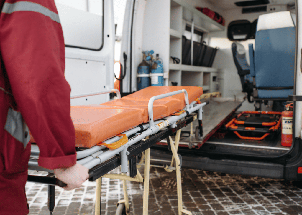 A team using a gurney in an ambulance