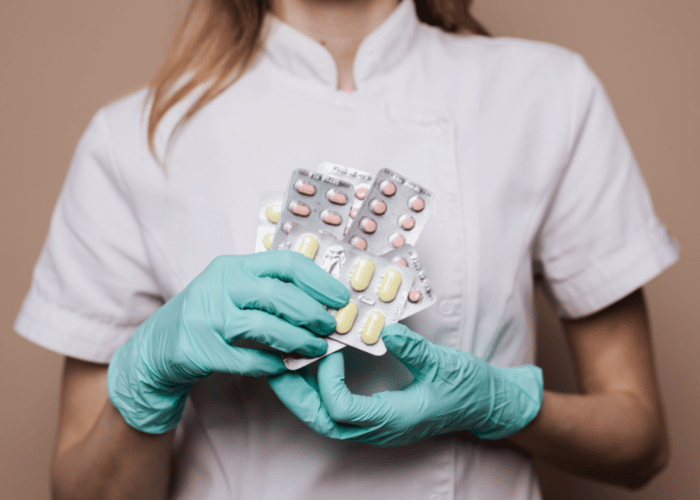 A medical professional holding pharmaceuticals