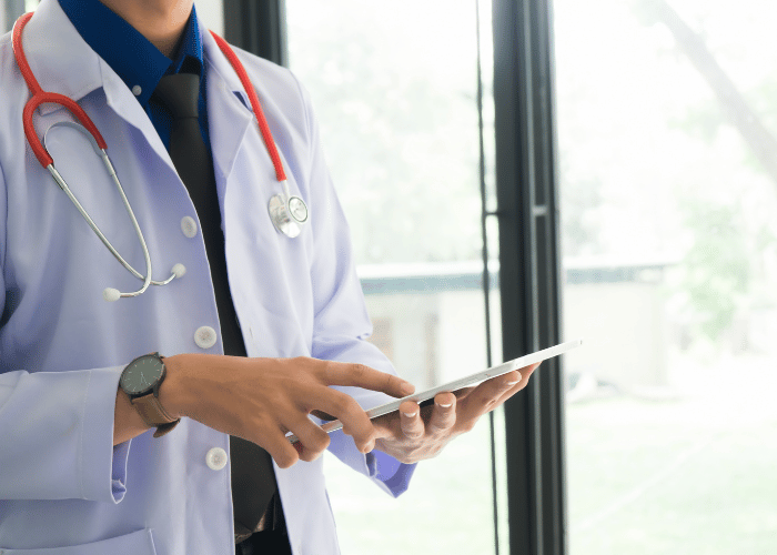 A doctor working on a tablet